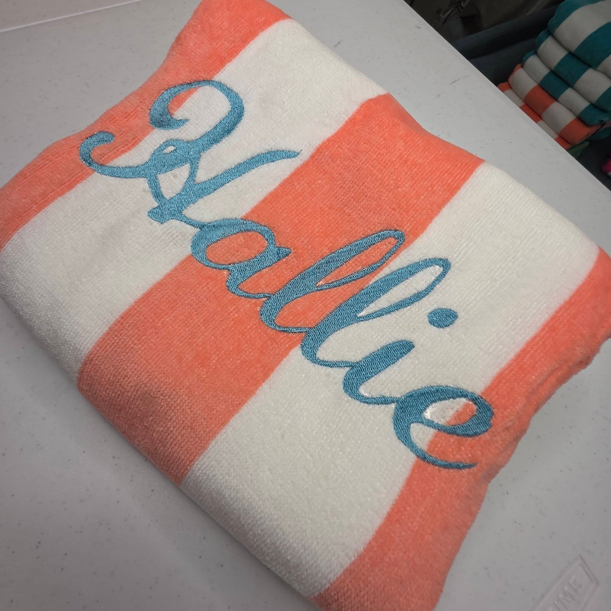 Close up of personalized cabana towel with embroidered name showing stitching detail