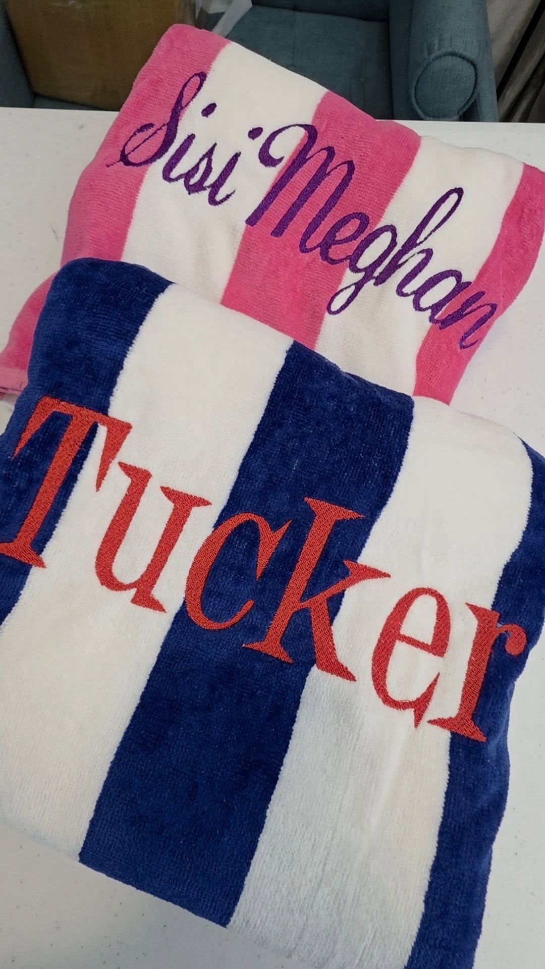Close up of personalized cabana towels with embroidered names showing stitch details